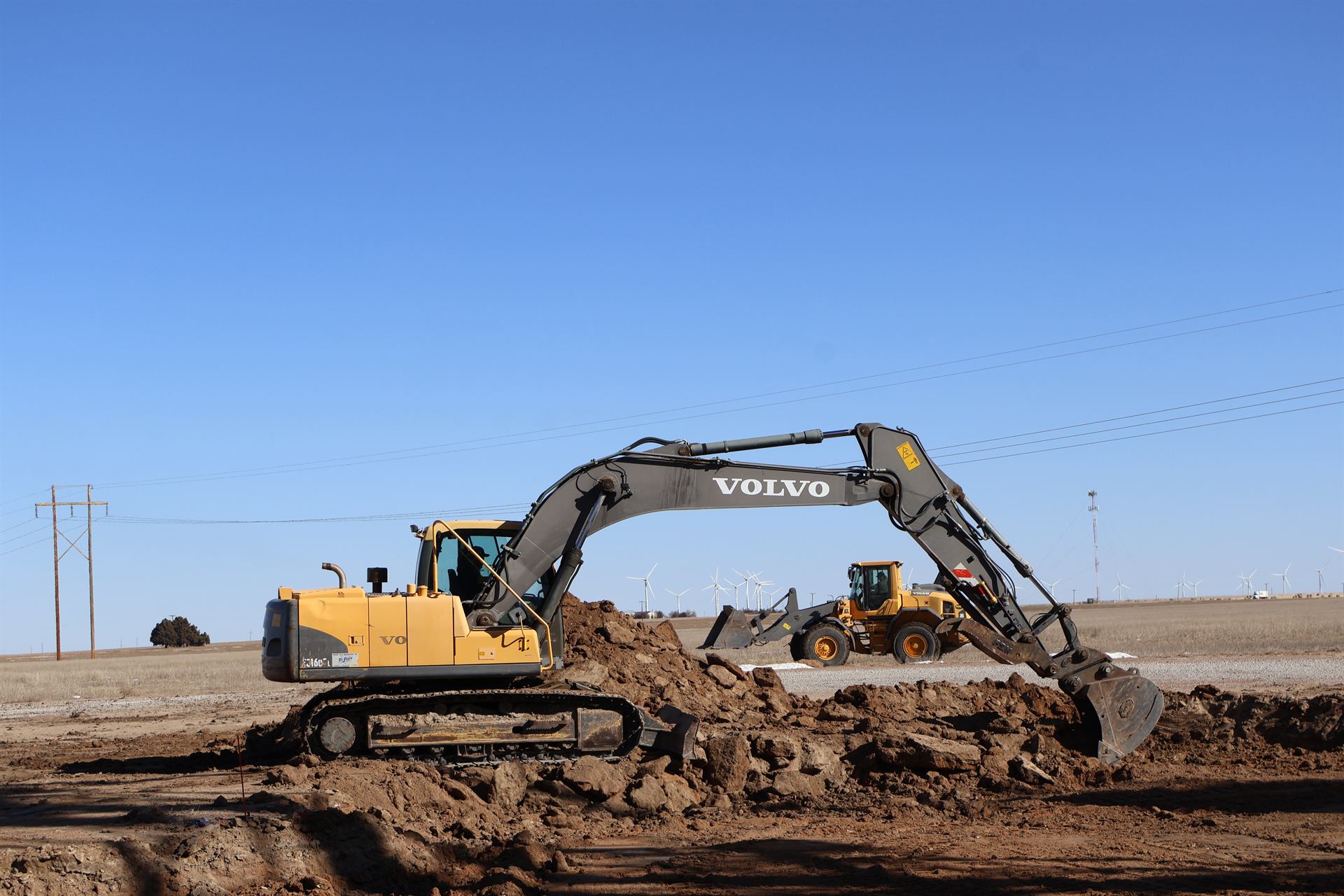 Topline Excavating equipment performing excavation work on a job site